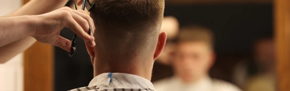 Barber cutting a male client’s hair.