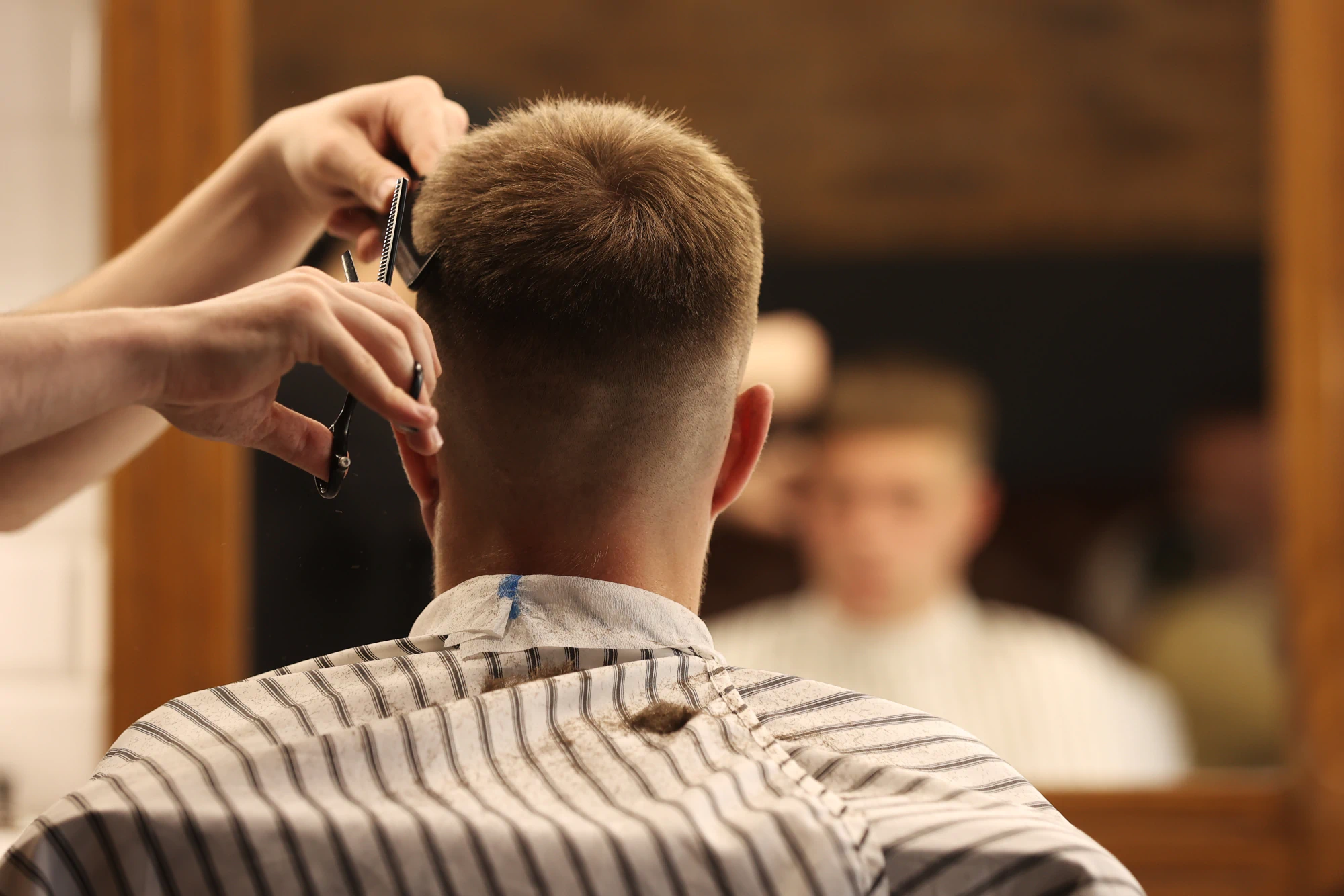 Barber cutting a male client’s hair.