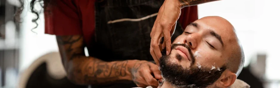 Barber trimming a client’s facial hair