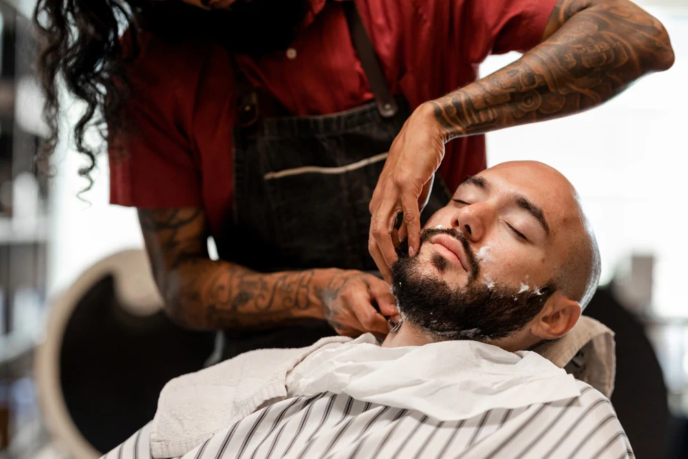 Barber trimming a client’s facial hair