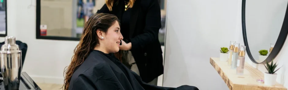 Beauty school student giving a client a haircut