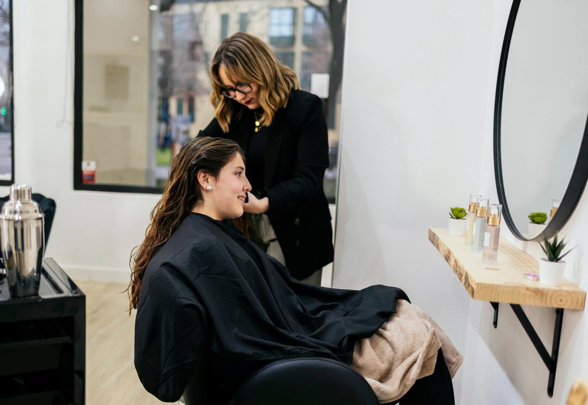 Beauty school student giving a client a haircut