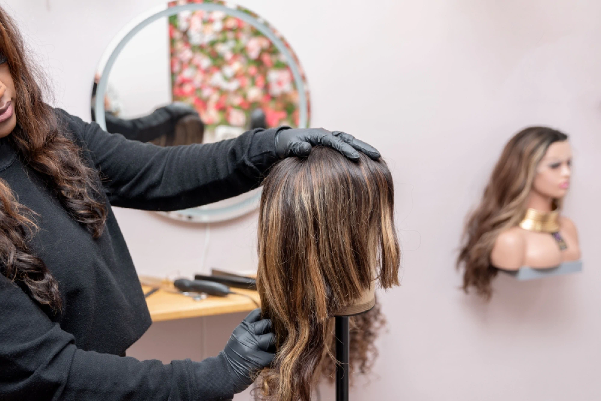 Cosmetology student practicing hair cutting on a mannequin