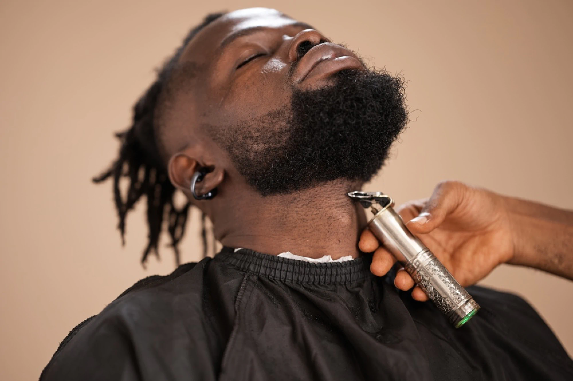 Client at the barber shop getting a beard trim
